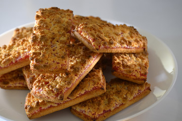 Cookies with strawberry jam on a white plate