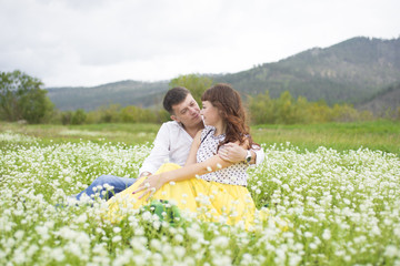 Fototapeta premium Lovers meet men and women on a beautiful flower field.