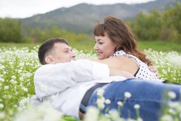 Lovers meet men and women on a beautiful flower field.