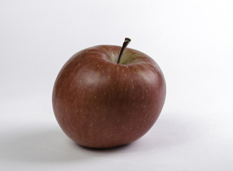 Red apple on a white surface