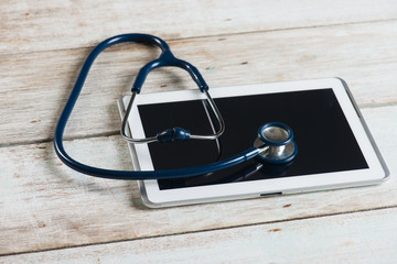 Top view of doctor desk with digital tablet with empty screen