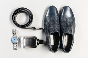 shoes and accessories for men lay on the wooden floor