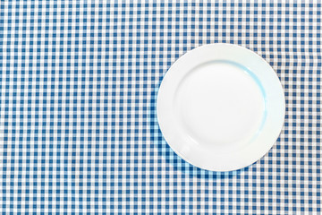 table with blue picnic cloth and plate