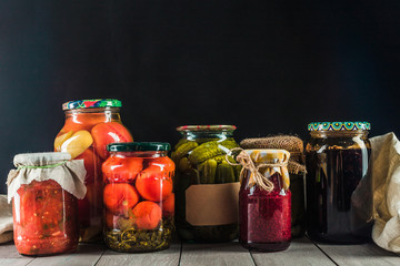 Preserved vegetables on wooden background