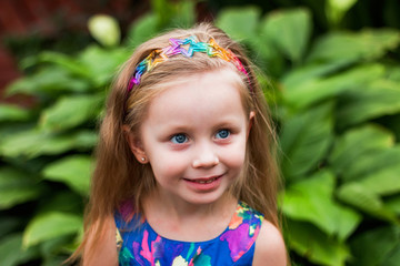 emotional portrait of a surprised girl in a botanical garden near the plant