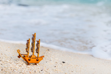 Fototapeta na wymiar Mini ship on the beach