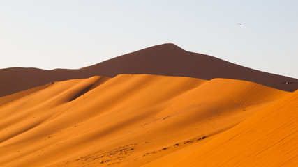 Red dunes of Namib Desert near Sossusvlei, aka Sossus Vlei, Namib-Naukluft National Park, Namibia, Africa.