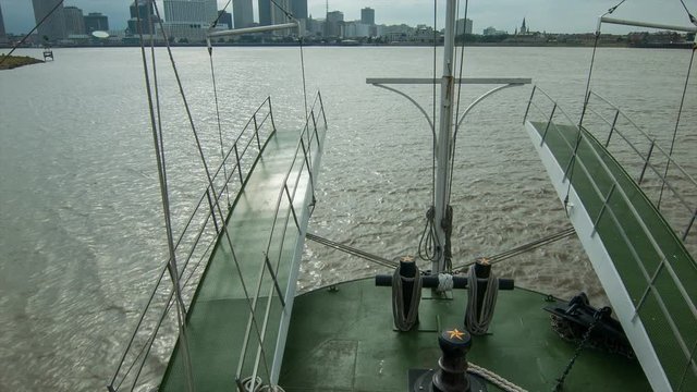 Onboard Mississippi River Steamboat Approaching New Orleans Louisiana Tilting Up from the Water Surface towards the Buildings of Downtown and French Quarter on the Horizon