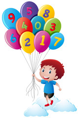 Little boy holding balloons with numbers