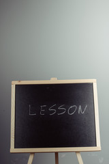 Lesson written in white chalk on a black chalkboard