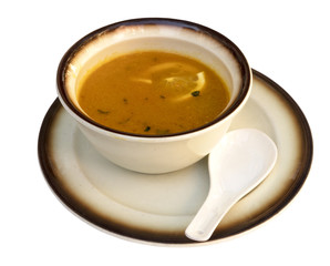 Bowl of chicken soup with lemon, isolated on white