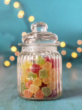 Gum drops in glass jar on blurred  background