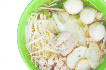 Noodles in green bowl on white background.