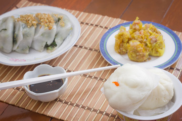 Steamed stuff bun (Salapao) and dumpling on mat bamboo.