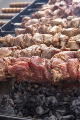 Brazier with live coals and unroasted kebabs.