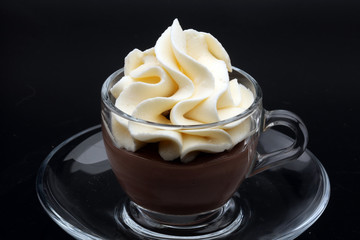 Hot chocolate cocoa with whipped cream on vintage wooden background, selective focus 