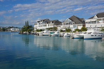 Fototapeta premium Noumea city, boats moored in a marina with residences, Orphelinat bay, Grande Terre island, New Caledonia, south Pacific 