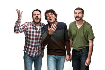 The three men are smiling, looking at camera