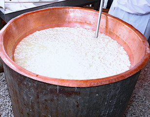 hot big copper cauldron with the curdled milk