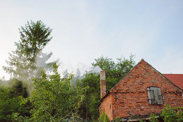 Fototapeta na wymiar Old brick cottage in a small town