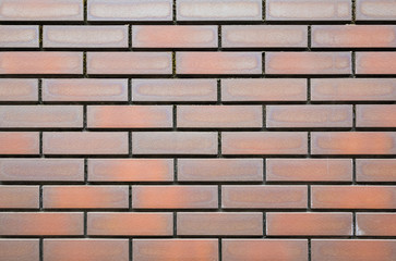 orange baked clay tile wall with lichen