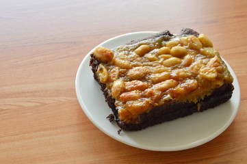 peanut butter caramel topping dark chocolate cake on dish