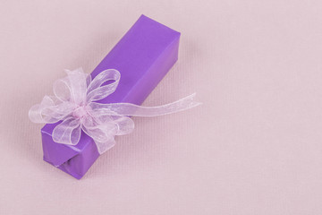 purple gift box with pink bow