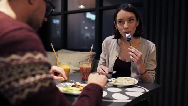 happy couple enjoying dinner at vegan restaurant