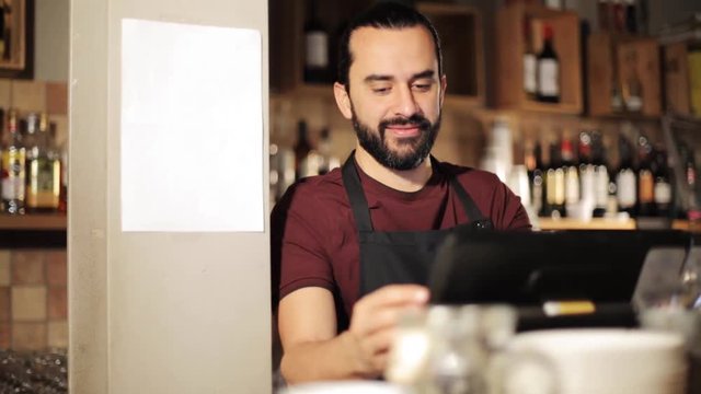 happy man or waiter at cashbox in coffee shop