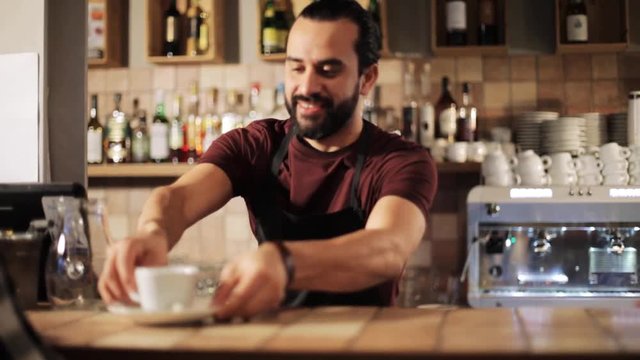man or waiter serving customer in coffee shop
