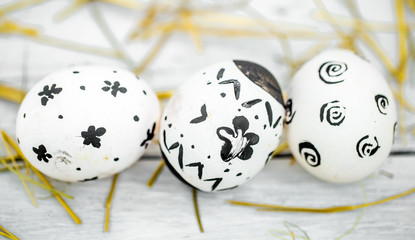 Easter composition with white eggs  black pattern