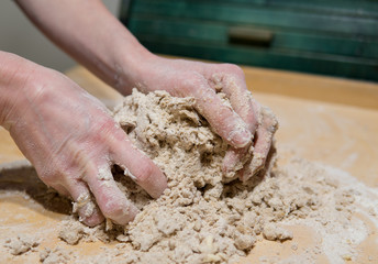 hands kneading cake dough