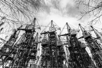 Fototapeta premium Several old building cranes. Heavy industry. Black and white.