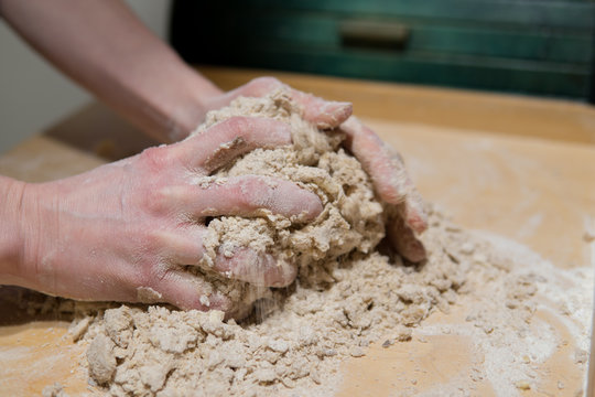 hands kneading cake dough