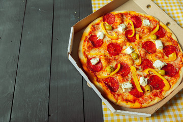 Fresh tasty pizza on wooden background