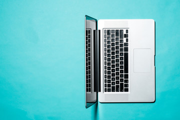 Top view of Laptop on blue background.