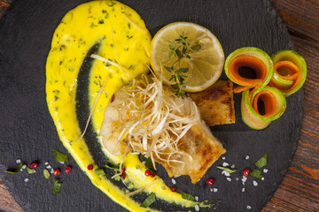 Pike perch with sauce and lemon