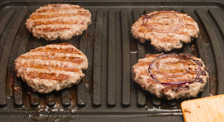 four pieces of fried meat grilled