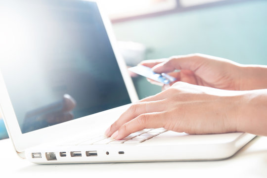 Woman hands on keyboard of laptop and holding credit card, Online shopping concept with copy space