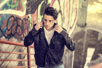 Young man standing outdoors in urban setting