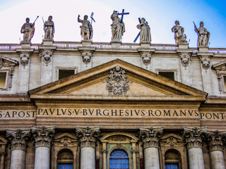 Fototapeta na wymiar Statues of the apostles on the roof of St Peter's Basilica in Vatican. Rome, Italy