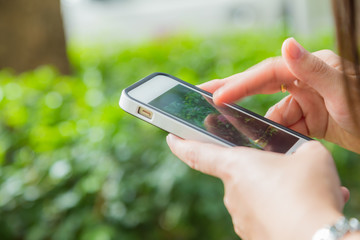 Hand of women using mobile smart phone with blank white screen