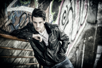 Young man standing outdoors in urban setting