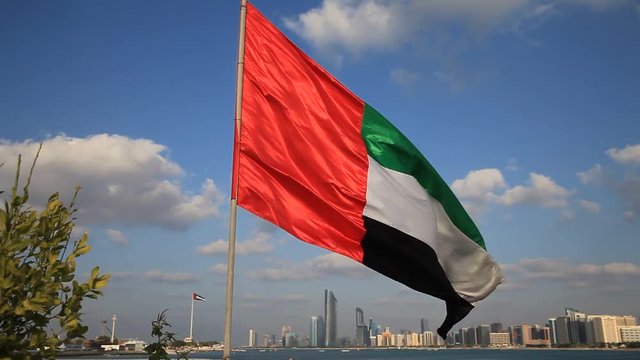 UAE flag waving with the background of Abu Dhabi Skyline as part of 43rd National Day celebrations