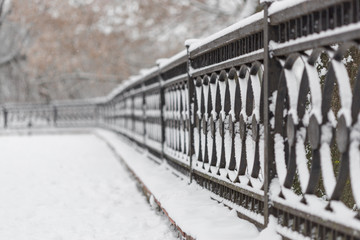 abstract background of snow-covered fence in the park