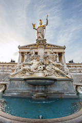 Fototapeta na wymiar facade of austrian parliament building with Pallas Athena fountain in Vienna, Austria