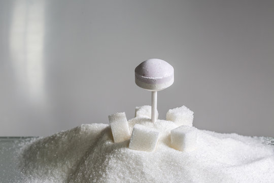 dextrose lollipop on sugar cubes and heaps of refined sugar