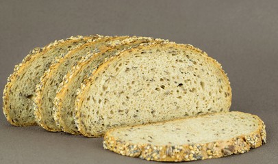 Slices of wholemeal grain bread on a brown background