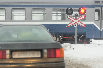 Gomel, Belarus - 25 DECEMBER 2016: cars are at the railway crossing, and the train passed.