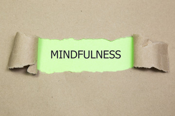 Mindfulness word written under torn paper